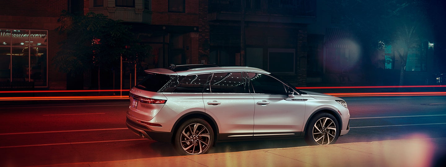 The 2024 Lincoln Corsair® SUV is parked on a city street at night. | Sentry Lincoln in Medford MA