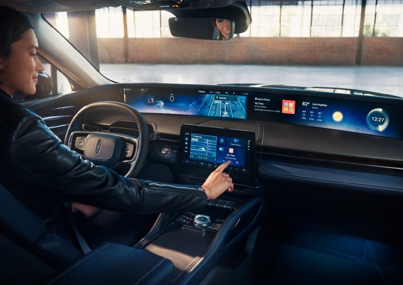 The driver of a 2024 Lincoln Nautilus® SUV interacts with the center touchscreen. | Sentry Lincoln in Medford MA